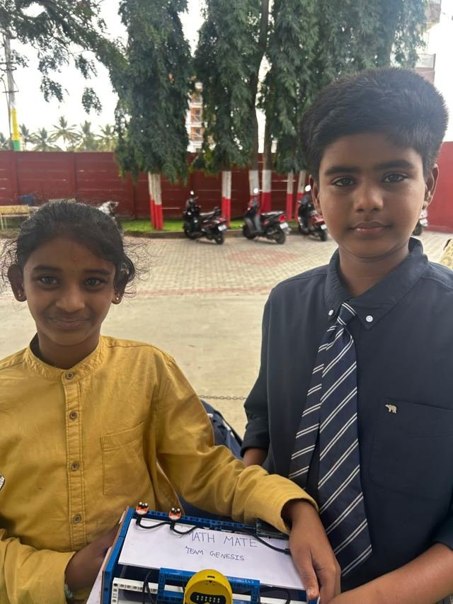 Two students hold up the project they built